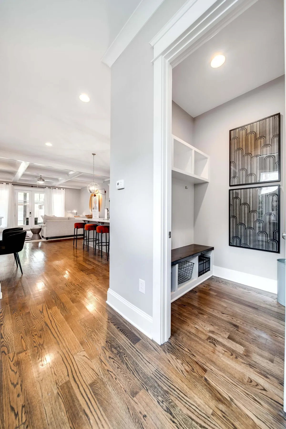 A welcoming entryway with a comfortable seating area and decorative wall art, setting a warm and inviting tone as guests enter the home. The space feels ready for celebrations or everyday gatherings.